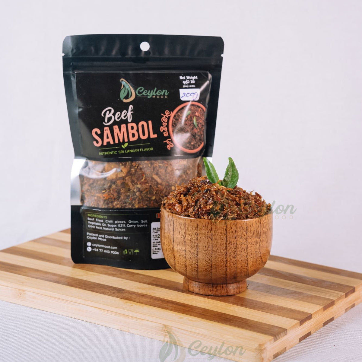 Ceylon Mood Beef Sambol pack with a wooden bowl of sambol on a wooden board