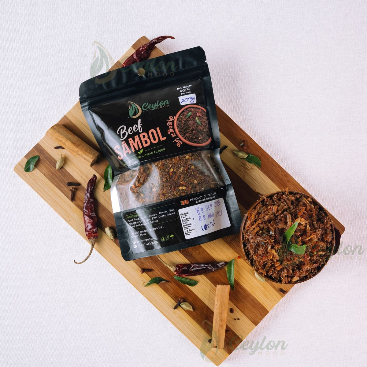 Top view of Beef Sambol pack and bowl with spices on a wooden board