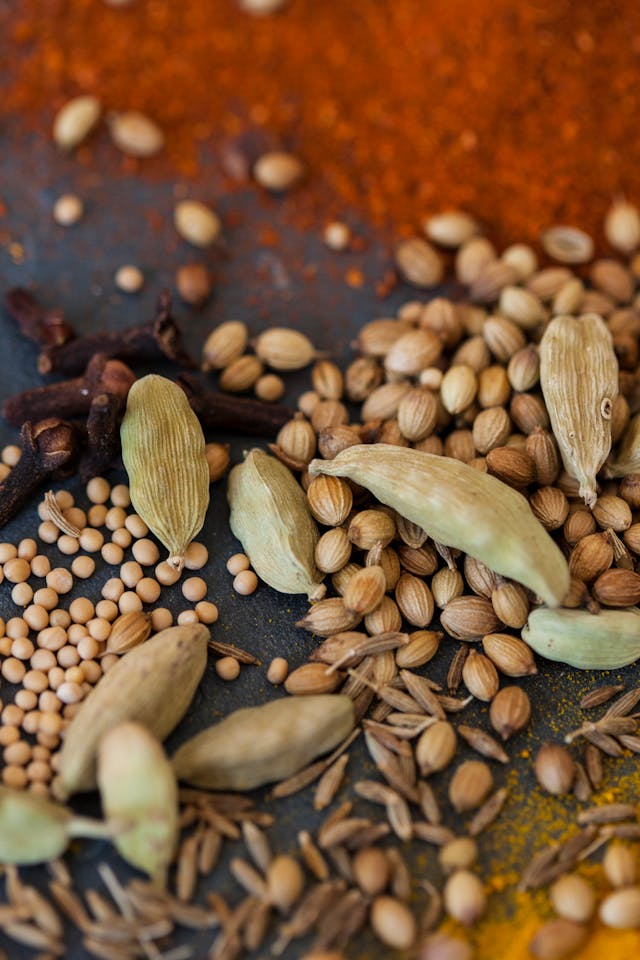 Cardamom pods, cloves and coriander seeds, the natural spices used in Sri Lankan sweets