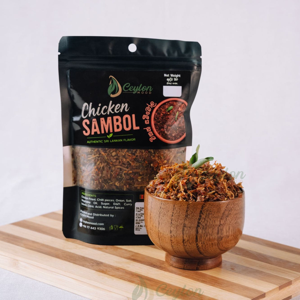 Ceylon Mood Chicken Sambol pack with a wooden bowl of sambol on a wooden board