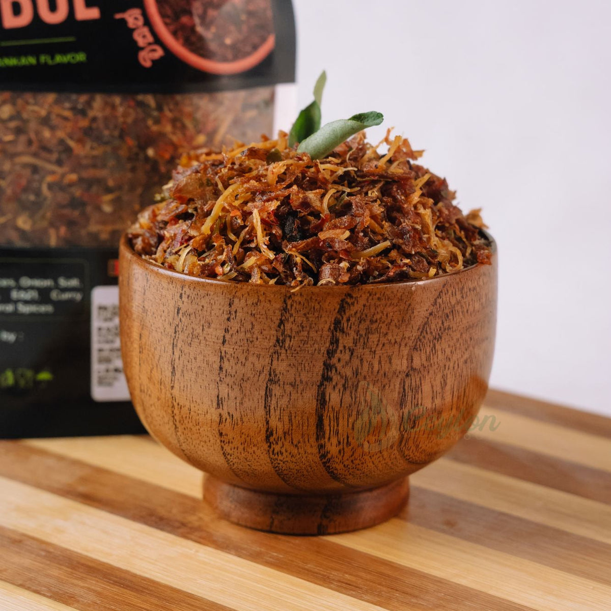 Close-up of crispy Sri Lankan chicken sambol in a wooden bowl