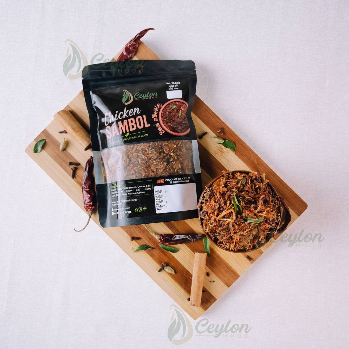 Top view of Chicken Sambol pack and bowl with spices on a wooden board
