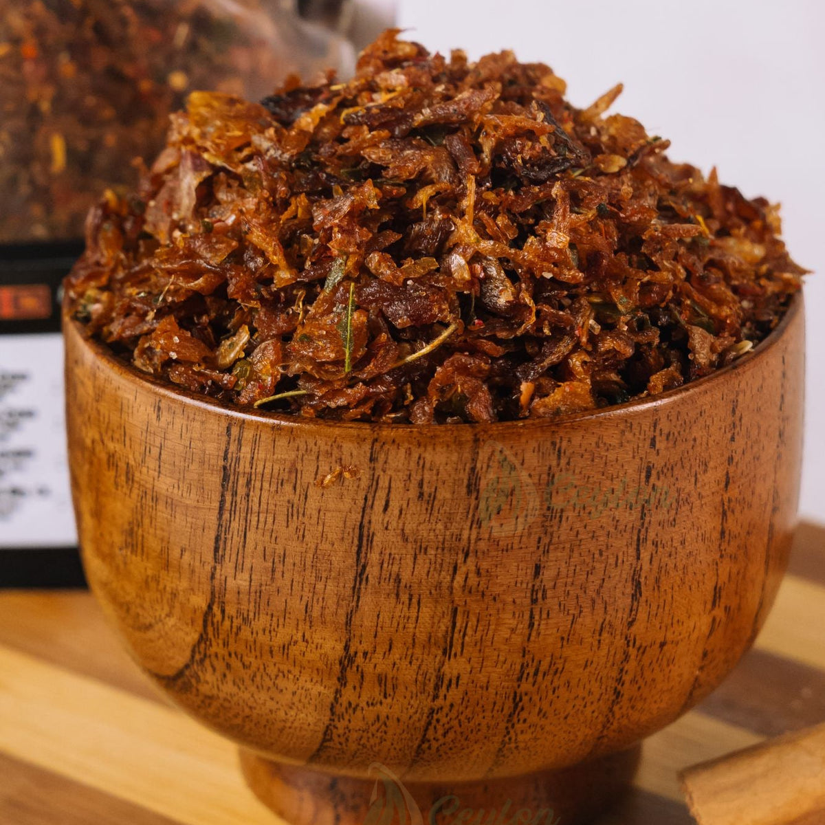 Close-up of crispy Sri Lankan dried shrimp sambol in a wooden bowl