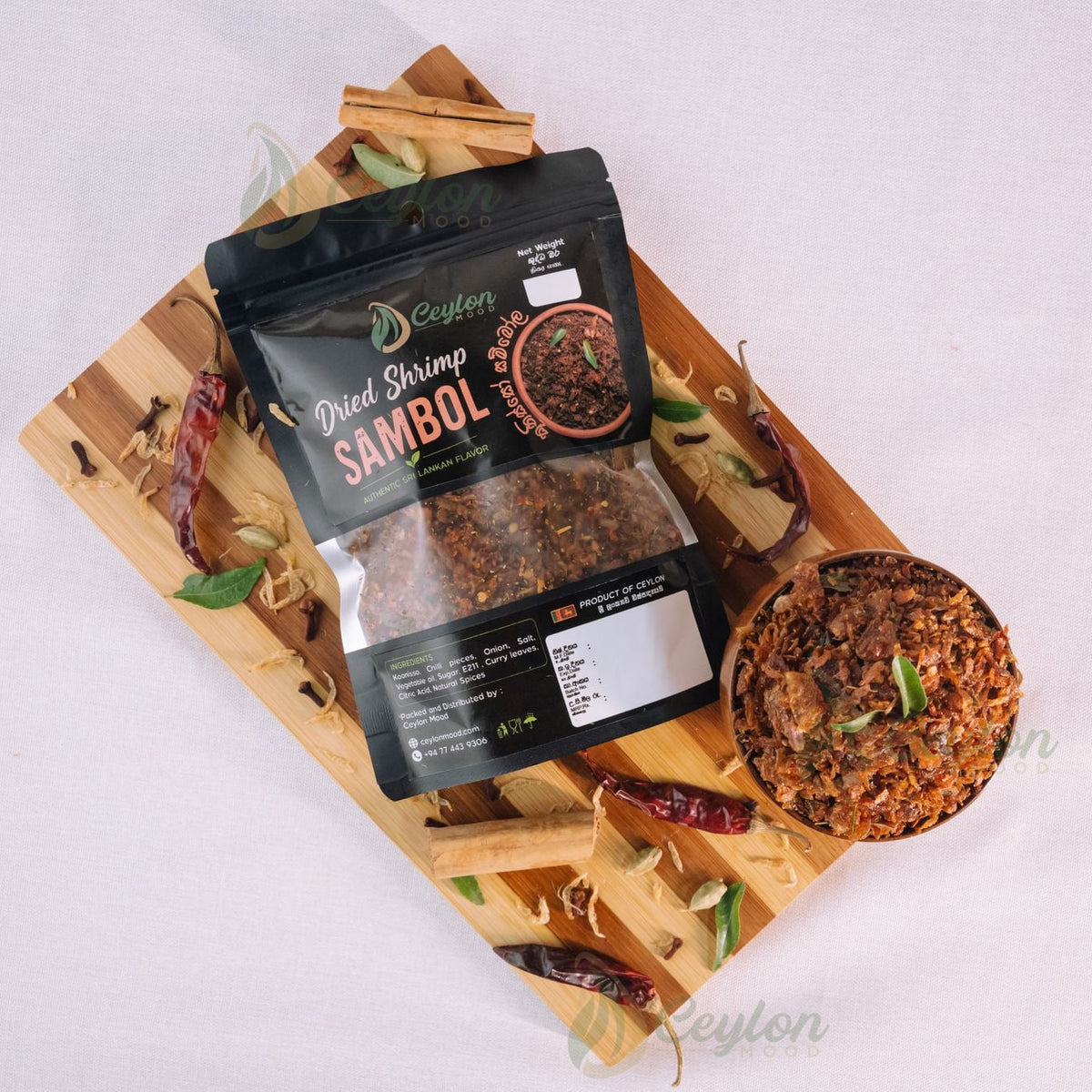 Top view of Dried Shrimp Sambol pack and bowl with spices on a wooden board