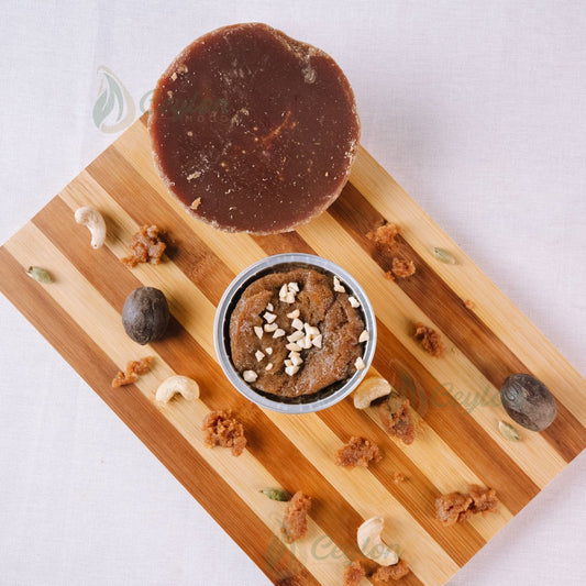 Kithul Watalappan in a foil basket with kithul jaggery and nutmeg on a wooden board, Ceylon Mood