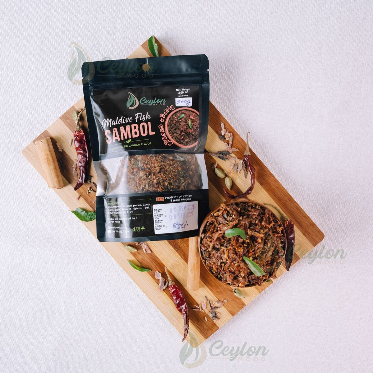 Top view of Maldive Fish Sambol pack and bowl with spices on a wooden board