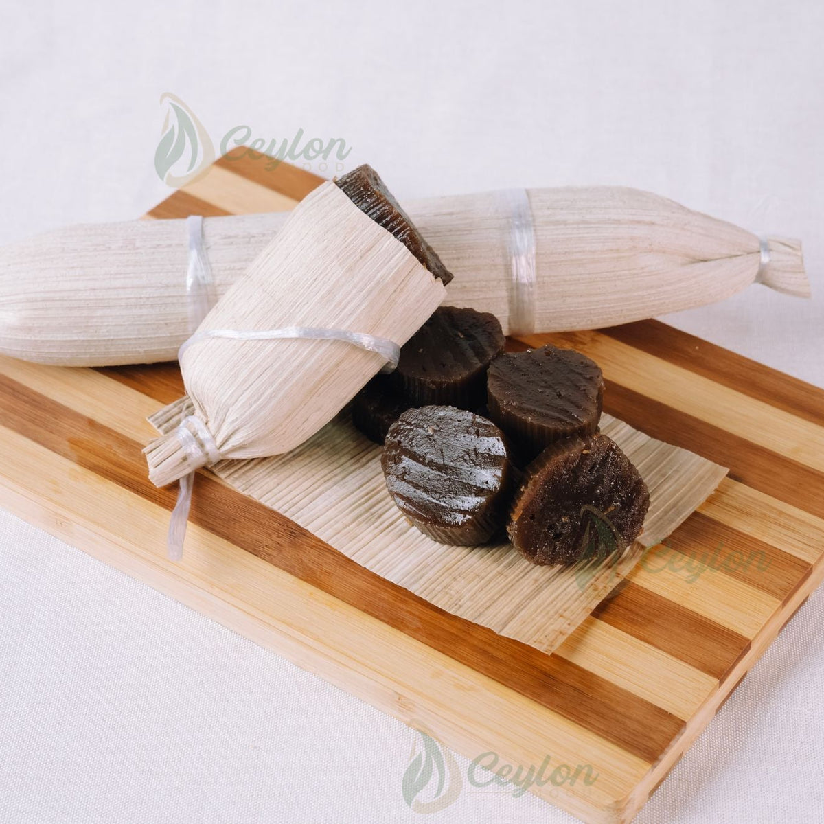 Patta Dodol wrapped in dried areca leaf with dodol pieces on a wooden board, handmade by Ceylon Mood