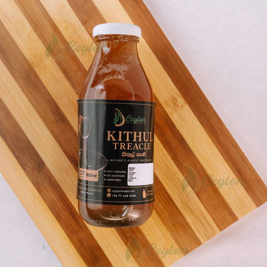 Top view of Pure Kithul Treacle bottle on a wooden board